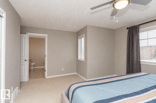 Carpeted flooring, ceiling fan with integrated lighting, multiple windows with blinds, and neutral wall tones - 192 Keyport Circle, Leduc, AB - Indoor Photo Showing Bedroom