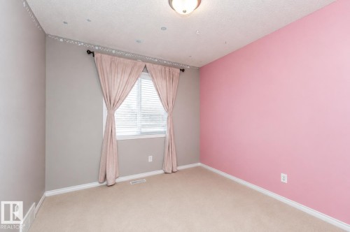 Carpeted flooring, window with blinds, ceiling-mounted light fixture, decorative wall border - 192 Keyport Circle, Leduc, AB - Indoor Photo Showing Other Room