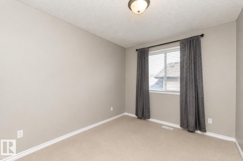 Neutral-toned walls, carpeted flooring, and a flush mount light fixture - 192 Keyport Circle, Leduc, AB - Indoor Photo Showing Other Room