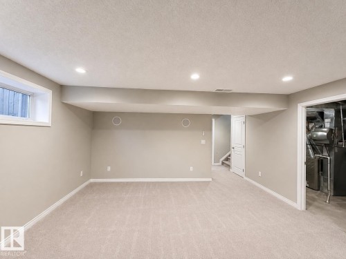 Recessed lighting, light-toned carpeting, neutral wall finishes, white trim, and a window for natural light - 192 Keyport Circle, Leduc, AB - Indoor Photo Showing Basement