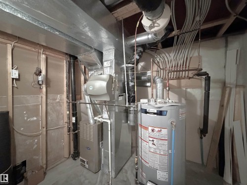 Utility area with a water heater, furnace, and extensive ductwork - 192 Keyport Circle, Leduc, AB - Indoor Photo Showing Basement