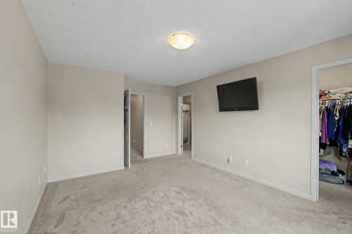 Carpeted room featuring neutral wall tones and a ceiling-mounted light fixture - 17304 73 Street Nw, Edmonton, AB - Indoor Photo Showing Other Room