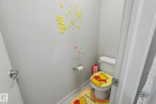 White toilet with a standard flush mechanism - 17304 73 Street Nw, Edmonton, AB - Indoor Photo Showing Bathroom