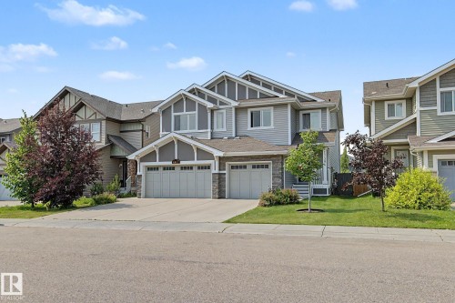 Contemporary exterior featuring horizontal siding, stone veneer accents, and multiple gables - 17304 73 Street Nw, Edmonton, AB - Outdoor With Facade