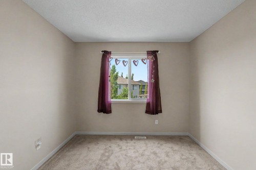Neutral-toned walls complement the light-colored carpeting - 17304 73 Street Nw, Edmonton, AB - Indoor Photo Showing Other Room