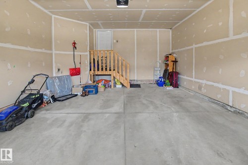 Spacious garage featuring concrete flooring and unpainted drywall - 17304 73 Street Nw, Edmonton, AB - Indoor Photo Showing Garage