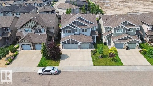 Modern residential street featuring multiple detached homes with varying architectural styles - 17304 73 Street Nw, Edmonton, AB - Outdoor With Facade