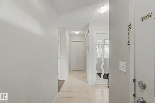 Entryway featuring tile flooring, white walls, and flush-mount ceiling lights - 17304 73 Street Nw, Edmonton, AB - Indoor