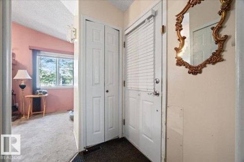 White entry door with internal blinds, paneled bi-fold closet doors, and light-colored carpeting - 121 51205 Range Road 195, Rural Beaver County, AB - Indoor Photo Showing Other Room