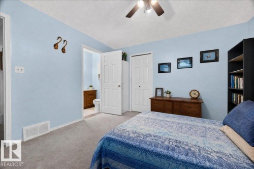 Spacious bedroom with light blue walls, ceiling fan, and carpet flooring - 121 51205 Range Road 195, Rural Beaver County, AB - Indoor Photo Showing Bedroom