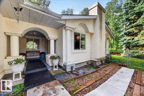 Arched entryway with substantial columns, stucco exterior finish, and a concrete pathway - 121 51205 Range Road 195, Rural Beaver County, AB - Outdoor