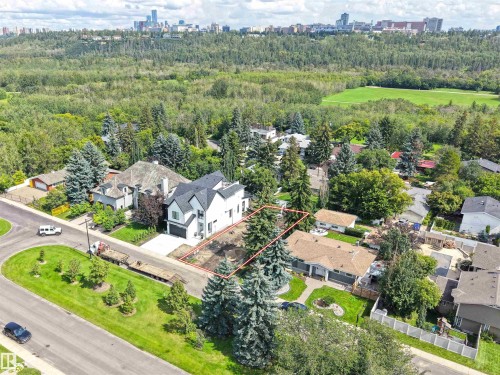 Expansive lot with mature trees, situated on a corner, offering a cityscape backdrop and proximity to a wooded area - 8203 134 Street Nw, Edmonton, AB 