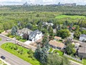 Expansive lot with mature trees, situated on a corner, offering a cityscape backdrop and proximity to a wooded area - 8203 134 Street Nw, Edmonton, AB 