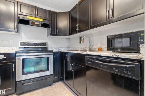 Black cabinetry paired with light-toned countertops - #30 3305 Orchards Link Sw Sw, Edmonton, AB 