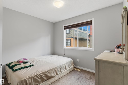 Recessed ceiling lighting, light gray painted walls, window with white trim, brown window blinds, and carpeted flooring - #30 3305 Orchards Link Sw Sw, Edmonton, AB 