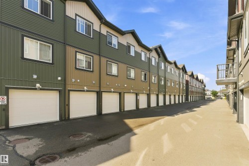 Multi-level townhome architecture with a row of individual garages - #30 3305 Orchards Link Sw Sw, Edmonton, AB 