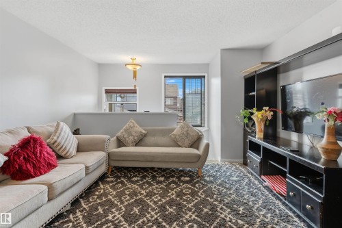 Recessed ceiling light fixture and a wall-mounted light fixture illuminate the interior - #30 3305 Orchards Link Sw Sw, Edmonton, AB 