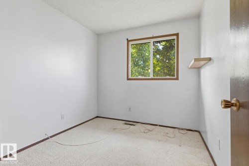 Wood-framed window, white walls, and light-colored carpet flooring - 3515 43 Avenue Nw, Edmonton, AB - Indoor Photo Showing Other Room