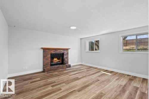 4209 25 Avenue Nw, Edmonton, AB - Indoor Photo Showing Living Room With Fireplace