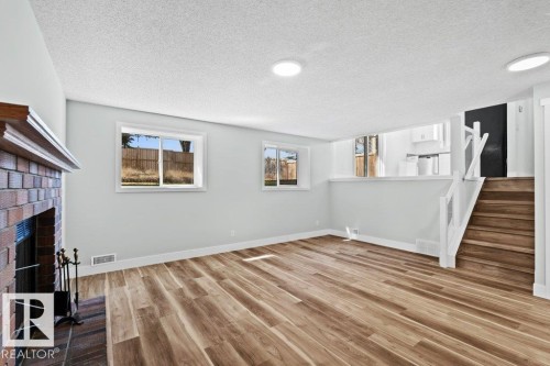 4209 25 Avenue Nw, Edmonton, AB - Indoor Photo Showing Other Room With Fireplace