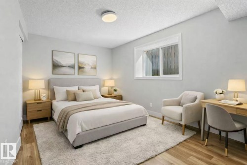 Wood-finish flooring with a neutral wall palette, a built-in window, and a flush-mount ceiling light - 4209 25 Avenue Nw, Edmonton, AB - Indoor Photo Showing Bedroom