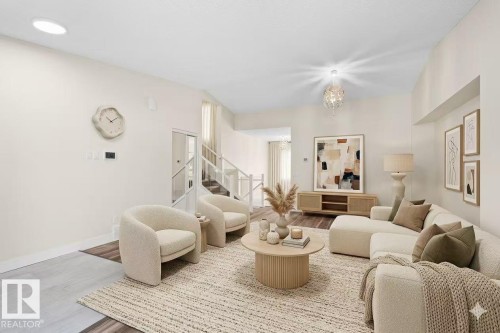 Bright living area featuring recessed lighting, a chandelier, and wood-finish flooring - 4209 25 Avenue Nw, Edmonton, AB - Indoor Photo Showing Living Room