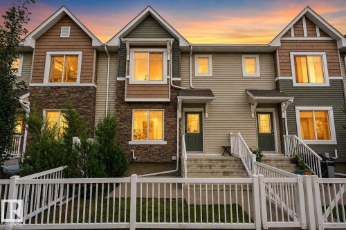 Multi-level townhome featuring stone veneer accents, horizontal siding, and multiple gables - #69 3625 144 Av Nw, Edmonton, AB - Outdoor With Facade