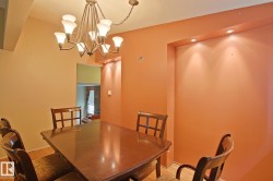 Recessed lighting and a decorative chandelier illuminate the space - 