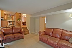 Wood-finish cabinetry, stainless steel range hood, and integrated kitchen appliances - 