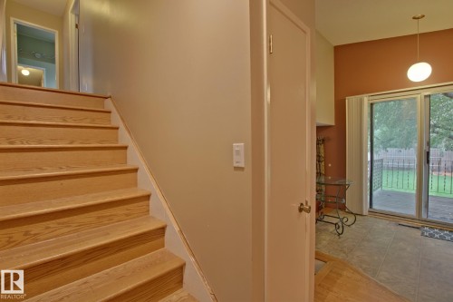 Wood-finish staircase leading to an upper landing - 18107 89 Avenue Nw, Edmonton, AB - Indoor Photo Showing Other Room