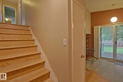 Wood-finish staircase leading to an upper landing - 