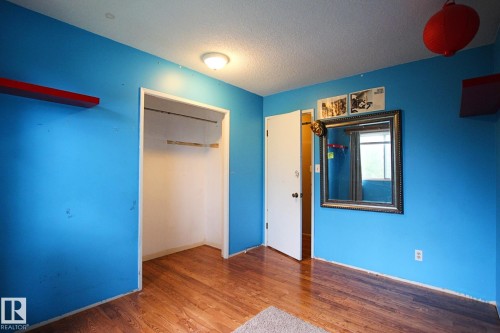 Wood-finish flooring with a ceiling-mounted light fixture - 18107 89 Avenue Nw, Edmonton, AB - Indoor