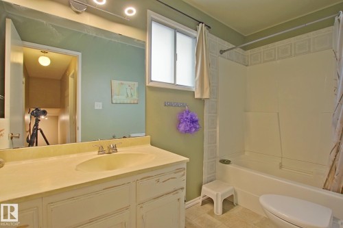 Single-sink vanity with built-in cabinetry and a laminate countertop - 18107 89 Avenue Nw, Edmonton, AB - Indoor Photo Showing Bathroom