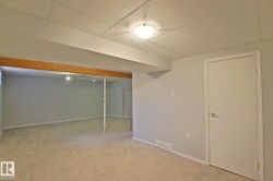 Carpeted flooring, neutral wall tones, recessed ceiling lighting, and a drop ceiling - 