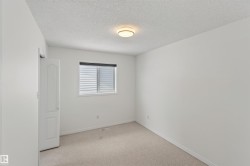 Carpeted flooring, white walls, window with horizontal blinds, flush mount ceiling light, interior door - 