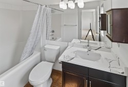 White tub and shower combination with white tile surround - 