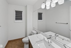 Modern vanity with an integrated sink, polished chrome faucet, and a quartz-finish countertop - 