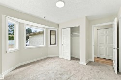 Recessed bay window, light grey carpeting, white trim, sliding closet doors, and a flush mount ceiling light - 