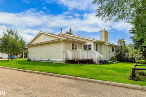 Exterior with stucco siding, a gabled roofline, and a prominent chimney - #21 9375 172 St Nw, Edmonton, AB - Outdoor