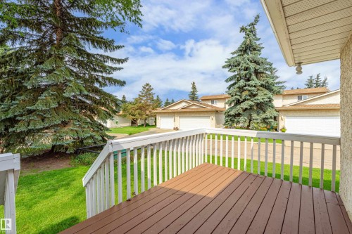 Exterior deck with wood-finish flooring and white railings - #21 9375 172 St Nw, Edmonton, AB - Outdoor With Deck Patio Veranda