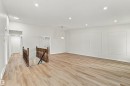 Spacious interior featuring wood-finish flooring, recessed lighting, and decorative wall paneling - #21 9375 172 St Nw, Edmonton, AB  - Indoor Photo Showing Other Room 