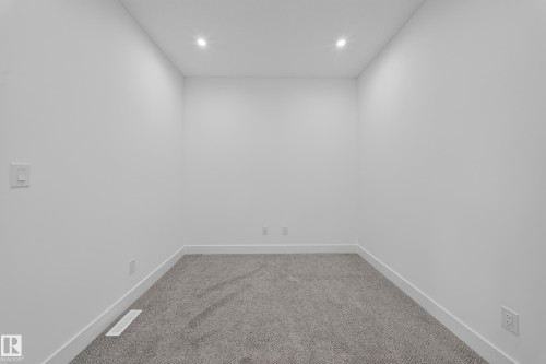 Recessed ceiling lighting illuminates a room with light gray carpeting and white walls - 222 Black Stone Drive Drive, Leduc, AB - Indoor Photo Showing Other Room