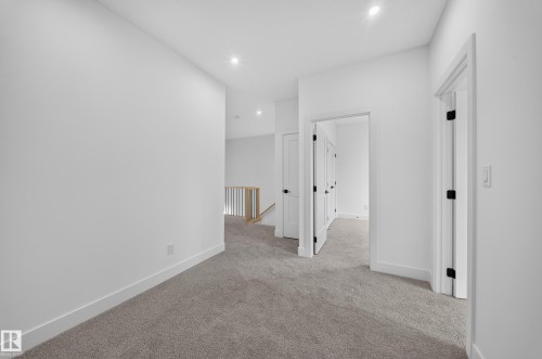 Plush carpet flooring, recessed lighting, white walls, and white trim - 222 Black Stone Drive Drive, Leduc, AB - Indoor Photo Showing Other Room