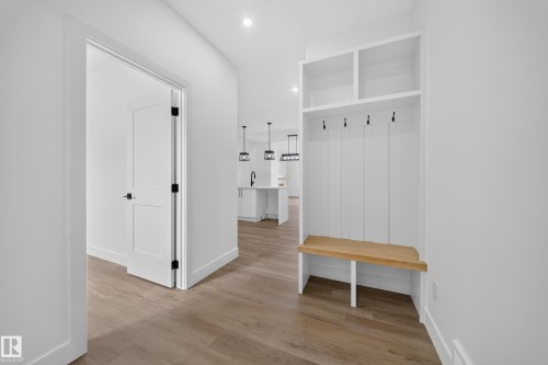 Built-in storage bench with overhead shelving and coat hooks - 222 Black Stone Drive Drive, Leduc, AB - Indoor Photo Showing Other Room
