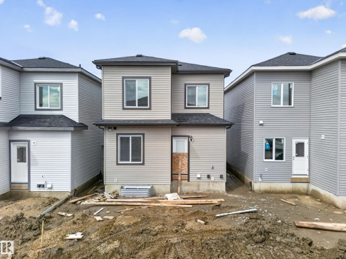 Two-story property with light gray horizontal siding and dark gray trim - 222 Black Stone Drive Drive, Leduc, AB - Outdoor With Exterior