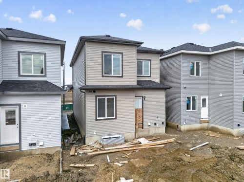 Two-story residences featuring horizontal siding and dark shingle roofing - 222 Black Stone Drive Drive, Leduc, AB - Outdoor With Exterior