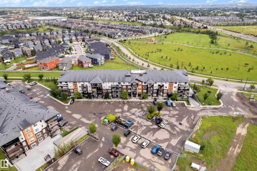 Multi-story residential buildings with surface parking, featuring balconies and contemporary exteriors - #227 148 Ebbers Bv Nw, Edmonton, AB - Outdoor With View