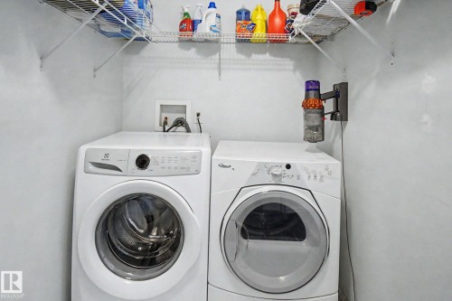 Laundry area with white walls and overhead wire shelving - 3236 21 Street Nw, Edmonton, AB - Indoor Photo Showing Laundry Room