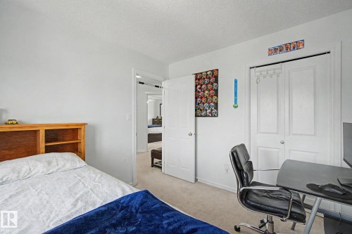 Light-toned carpet flooring and white walls - 3236 21 Street Nw, Edmonton, AB - Indoor Photo Showing Bedroom