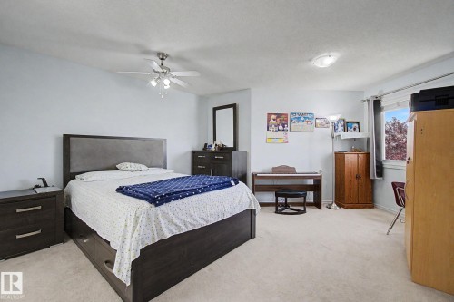 Recessed lighting, ceiling fan, window with curtain rod, and light-toned carpeting - 3236 21 Street Nw, Edmonton, AB - Indoor Photo Showing Bedroom